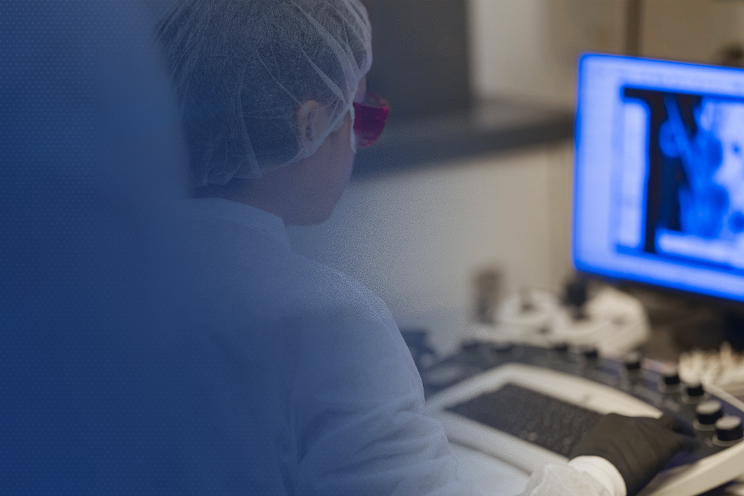 test man in lab coat in front of computer screen